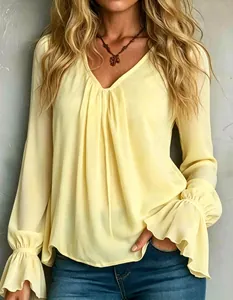Close-up of elegant V-neck pleated loose long-sleeved light yellow blouse for women