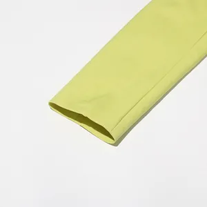 Close-up detail of lime green blazer sleeve showing high-quality fabric texture and seam.