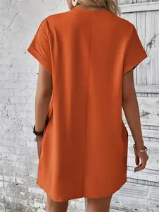 Back view of minimalist orange crew neck loose short sleeve dress with side pockets