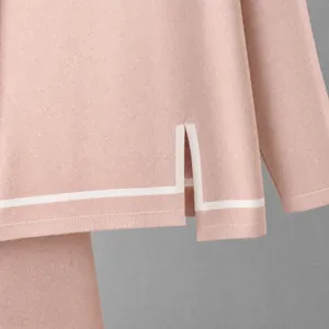 Close-up detail of pink knit two-piece set featuring side slit hem with white contrast piping.