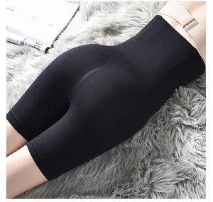Detail view of seamless high-waisted black shapewear shorts on a plush textured rug