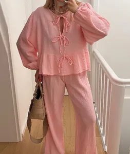 Elegant pink two-piece lounge set with lantern sleeves bow-tie top and matching trousers