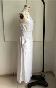 Side view of white bohemian sleeveless backless jumpsuit with gathered waist detail.