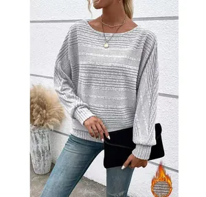 Detail of women's grey textured long sleeve top featuring warm thermal fleece lining inside