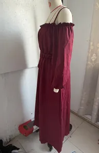 Side view of burgundy off-shoulder cotton linen long dress with ruffles on a mannequin.