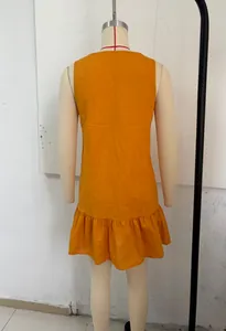 Rear view of a sleeveless orange resort dress with ruffled hem on a dress form.