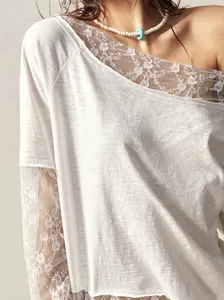 Close-up detail of white bohemian off-shoulder T-shirt with elegant floral lace trim
