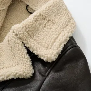 Detailed macro view showing the soft faux shearling collar and leather grain of the jacket.