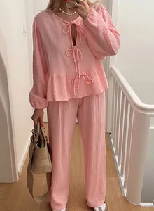Elegant pink muslin two-piece set with lantern sleeve tie-front top and wide leg pants