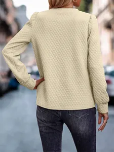 Back view of a cream-colored diamond quilted sweatshirt featuring elegant puff sleeves