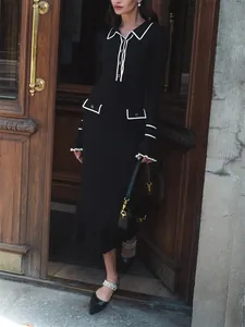 French style black knit midi dress with white piping and ruffle cuffs detail