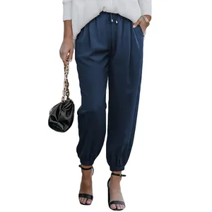 Detail of navy blue high-waisted drawstring jogger pants with elastic cuffs for women