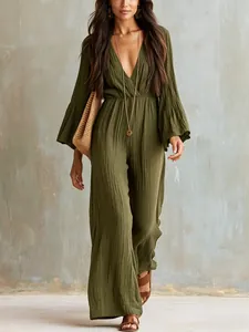 Detail view of a bohemian olive green V-neck long-sleeve wide-leg jumpsuit on a model