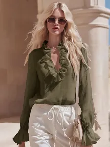 Close-up view of olive green linen blouse featuring elegant ruffled V-neck design details.