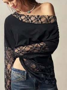 Detail view of black bohemian t-shirt featuring elegant lace off-shoulder neckline.