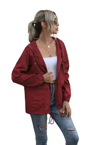 Side view of lightweight burgundy hooded rain jacket showing drawstrings and pockets.
