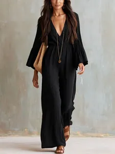 Detailed view of bohemian black V-neck wide-leg jumpsuit with long sleeves and textured fabric