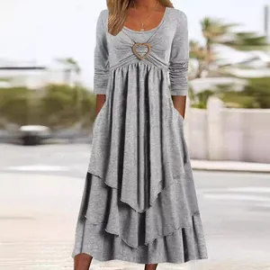 Casual grey tiered maxi dress featuring a cinched waist and heart buckle accent