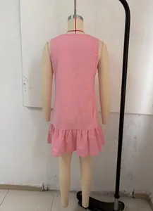 Detailed back view of pink sleeveless vintage holiday dress featuring a ruffle hem