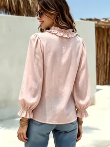 Detailansicht der Rückseite einer rosa Damenbluse im französischen Stil mit Rüschen.