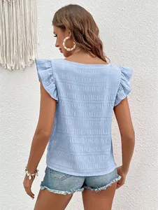 Back view of light blue ruffled short sleeve blouse with elegant textured fabric details