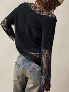 Close-up of bohemian black long sleeve t-shirt featuring intricate lace sleeves and back.