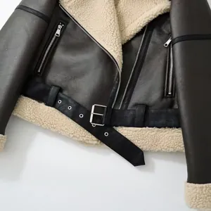 Close-up detail of a women's dark brown faux leather shearling biker jacket with belt
