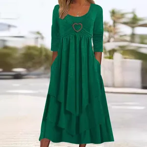 Elegant dark green long sleeve dress featuring heart decor and a tiered cake hem skirt