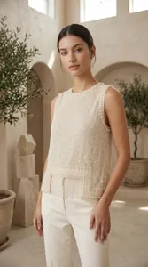 Detailed view of elegant sleeveless vest with intricate pearl embroidery and fringe tassels.