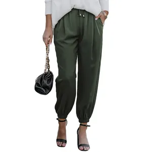 High-waisted drawstring joggers in dark green featuring elastic cuffs and side pockets.