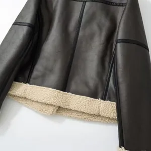 Close-up detail of women's leather motorcycle jacket with cream shearling lining