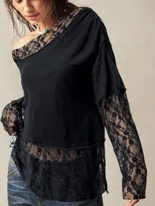 Detail of bohemian black off-shoulder T-shirt featuring intricate lace sleeves and hemline