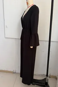 Side view of a black Bohemian V-neck long sleeve wide-leg jumpsuit on a mannequin