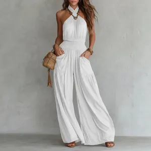 White bohemian backless halter wide-leg jumpsuit with smocked waist and side pockets