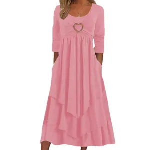 Elegant pink long sleeve tiered cake hem maxi dress featuring heart shaped chest decoration