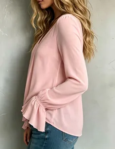 Close-up detail of elegant pink V-neck blouse with ruffled bell cuffs for women