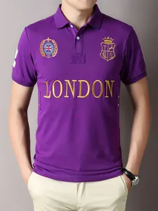 Close-up of purple cotton polo shirt with gold London embroidery and crest detail