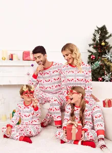 Detail view of family matching Christmas pajamas with festive red reindeer patterns.