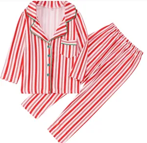 Vista de detalle del pijama navideño a rayas rojas y blancas con vivos y botones verdes
