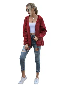 Detail view of women's lightweight red hooded jacket for outdoor hiking and rain protection