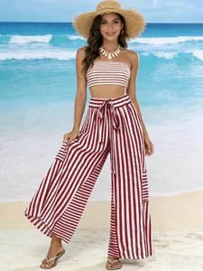 Full body view of women's red striped high waist wide leg pants set on beach background