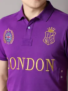 Close-up detail showing London embroidery and UK flag on purple cotton polo shirt