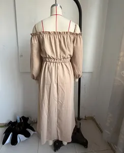 Back view of a beige cotton linen off-shoulder maxi dress with ruffled neckline and waist.