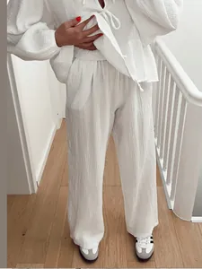 Casual white lantern sleeve tie-front top and wide-leg trousers set in textured fabric