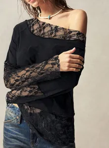 Close-up of black bohemian T-shirt with lace sleeve details and off-shoulder cut