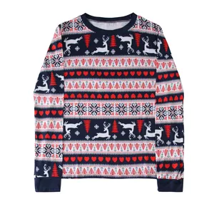 Detail of Christmas pajama top with reindeer and tree prints on navy blue background