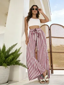 Detailed look at high-waisted red and white striped wide-leg trousers for women