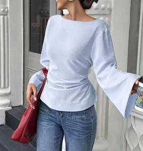 Detailed macro shot of a light blue boat neck T-shirt with stylish bell sleeve design.