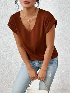Chic rust brown V-neck T-shirt with rolled sleeves shown in an elegant lifestyle pose