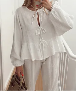 Detail view of stylish white lantern sleeve tie-front top and matching pants set